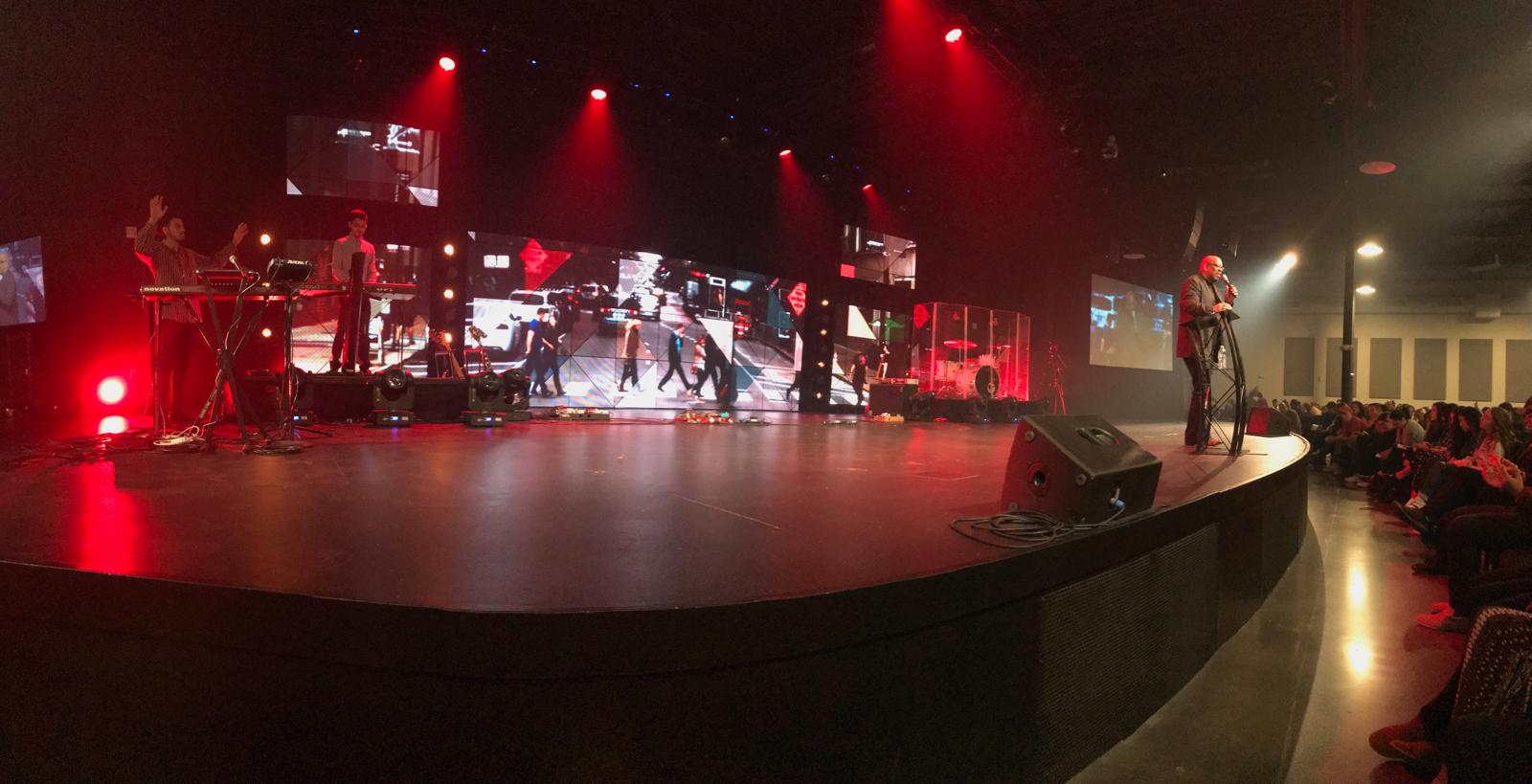 Dr. Alfred Smith speaking on stage at a large event